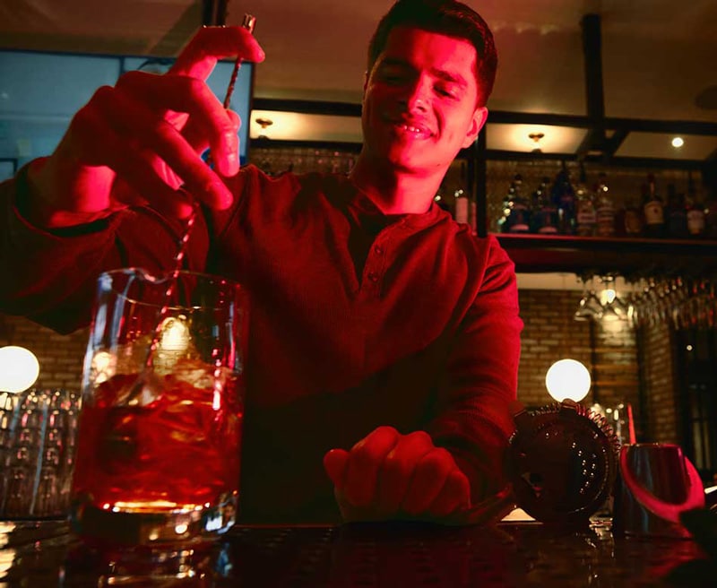 Bartender stirring a cocktail